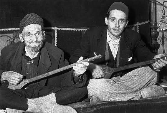 Two men playing stringed instruments. Slavic poets.