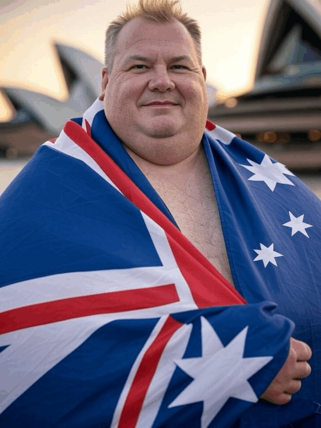 Overweight white man wrapped in the Australian flag.