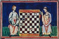 Chess board between to medieval players.