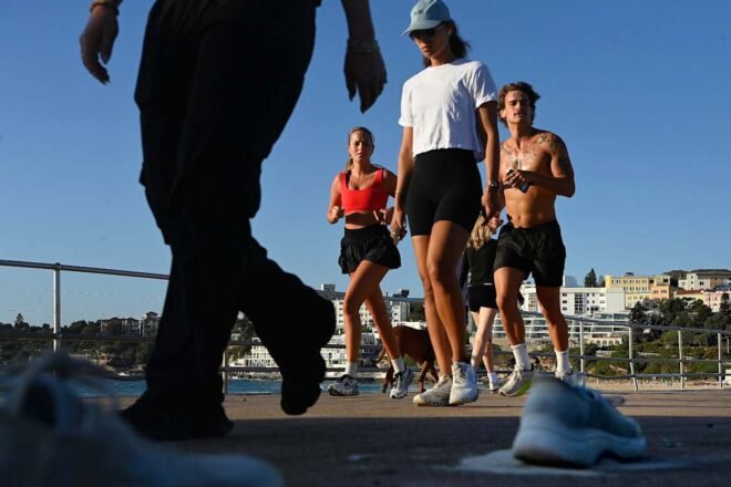 Runners passing by abandoned shoes after the Bondi terrorist incident.