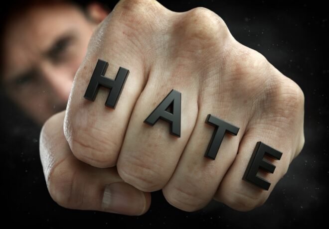 Hate printed across the knuckles of a fist.