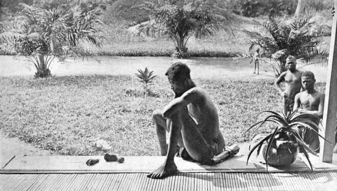 Photograph taken by Alice Seeley Harris of Nsala in the Congo, looking at the severed appendages of his child.